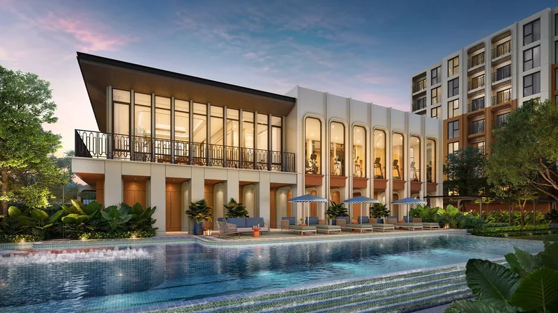 The Base Midtown Phuket clubhouse and pool at dusk
